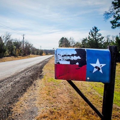 Texas flag mailbox along a farm road